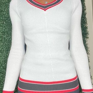 White long sleeve ripped nit top with black and red trimming